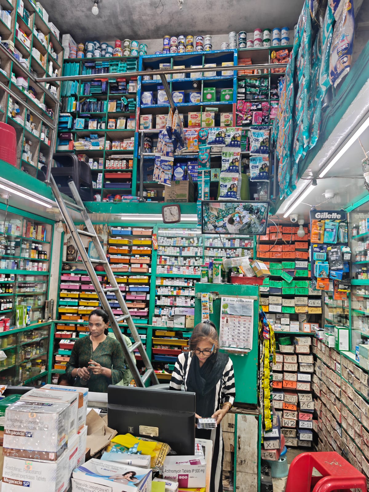 pharmacist arranging medicines at Malu Medicos medical store in Ballarpur